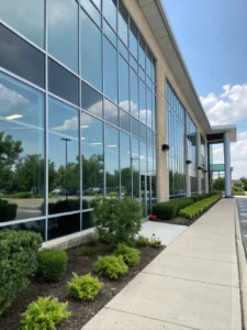 A commercial building with sparkling clean windows, reflecting the sky.